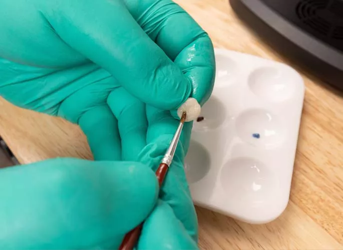 Dentist working on dental crown